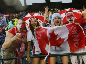EDMONTON, AB - JUNE 11: Canadian fans cheer during a rain delay in their match against New Zealand during the FIFA Women's World Cup Canada Group A match between China and Netherlands at Commonwealth Stadium on June 11, 2015 in Edmonton, Alberta, Canada.  Todd Korol/Getty Images/AFP