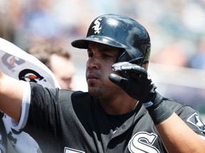 Chicago White Sox designated hitter Jose Abreu receives congratulations from teammates after scoring in the fourth inning against the Detroit Tigers at Comerica Park in Detroit on June 28, 2015. (RICK OSENTOSKI/USA TODAY Sports)