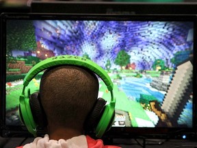 A child plays video game "Minecraft" at the Minecon convention in London July 4, 2015. The 10,000 tickets sold for Minecon in London made it the largest ever convention for a single video game. REUTERS/Matthew Tostevin