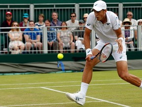 Vasek Pospisil of Canada returns a ball to  Viktor Troicki of Serbia during their singles match at the All England Lawn Tennis Championships in Wimbledon, London, Monday July 6, 2015. (AP Photo/Alastair Grant)