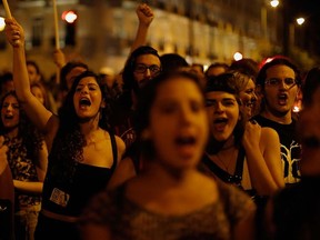 Supporters of the "No" vote react after the results of the referendum at Syntagma square in Athens, Sunday, July 5, 2015.  (AP Photo/Emilio Morenatti)