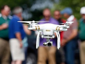 In this June 11, 2015, photo, a DJI Phantom 3 drone is flown by Matthew Creger, marketing director for Intelligent UAS, during a drone demonstration at a farm and winery on potential use for board members of the National Corn Growers in Cordova, Md. (AP Photo/Alex Brandon)