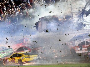 Austin Dillon (3) goes airborne and hits the catch fence as he was involved in a multi-car crash on the final lap of the NASCAR Sprint Cup series auto race at Daytona International Speedway, Monday, July 6, 2015, in Daytona Beach, Fla.  (Stephen M. DoweLl/The Orlando Sentinel via AP)