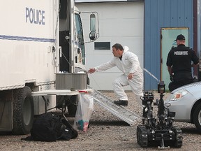 Police investigate at a business in Winnipeg, Man., in connection with a bombing on July 5, 2015. (Brian Donogh/Winnipeg Sun/Postmedia Network)