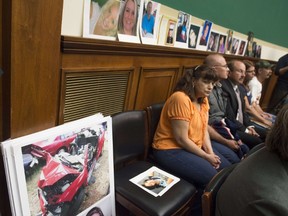 This June 18, 2014 file photo shows family members of victims resulting from problems with GM ignition switches as they sit alongside their loved ones' photographs during a US House Oversight and Investigations Subcommittee hearing on Capitol Hill in Washington, DC. AFP PHOTO/Saul LOEB