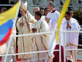 Pope Francis, center, exits Mass at the Samanes Park in Guayaquil, Ecuador, Monday, July 6, 2015. Latin America's first pope arrived in this port city on Monday for the first big event of a three-nation tour that includes Paraguay and Bolivia. (AP Photo/Fernando Vergara)