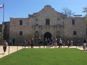 Visitors walk at the entrance to the Alamo, the most-visited tourist site in the state, in San Antonio, Texas March 2, 2015. (Reuters/Lisa Maria Garza)