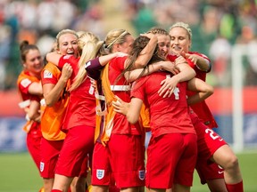England's players celebrate Fara Williams' goal during extra time of their bronze medal match against Germany at the FIFA Women's World Cup in Edmonton, Alberta on July 4, 2015.  AFP PHOTO/GEOFF ROBINS