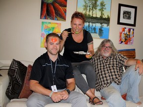 SARAH HYATT/THE INTELLIGENCER
Health promoter David Patterson (left) and artists Lisa Morris and Peter Paylor play around with a little paint at the artists’ home in Belleville, Monday. The trio is preparing to start a unique project on Wednesday that helps youth and encourages tobacco free environments.