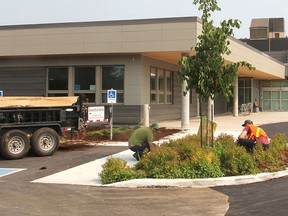 Work continues on the parking lot of the Kingston Community Health Centres in Kingston, Ont. on Mon., July 6, 2015, which is just $50,000 short of its $1.5 million fundraising goal for its new building. Michael Lea/The Whig-Standard/Postmedia Network