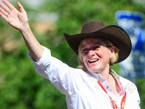 Alberta Premier Rachel Notley waves at the crowd at the 2015 Stampede Parade in Calgary, Alta on Friday Jul 3, 2015. Gavin John/STR/Calgary Sun