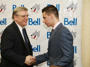 Sudbury Wolves president/general manager Blaine Smith shakes hands with David Levin at a press conference to introduce Levin as the first-overall pick in the 2015 OHL Priority Selection. John Lappa/The Sudbury Star/Postmedia Network