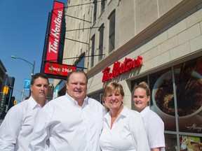 Co-owners Brad Sparling, Chris Sparling, Sue Sparling and Angela Hanley were happy the city allowed the Mascot Restaurant sign on Dundas Street to be grandfathered and re-used as Tim Hortons. (MIKE HENSEN, The London Free Press)