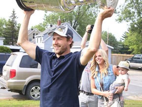 Lively's Andrew Desjardins proudly shows the Stanley Cup to friends, family and fellow Greater Sudburians during an event in the Chicago Blackhawks' hometown of Lively on Monday. Hundreds of people lined up for hours at TM Davies Arena in Lively to meet Desjardins and the cup.