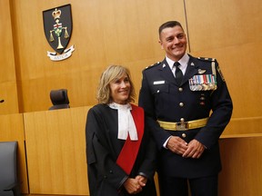 Ron Gignac, right, was sworn in by Madam Justice Elaine Deluzio as the new deputy chief of police for Belleville on Monday.