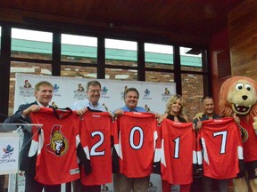 (From left) Team president Cyril Leeder, Mayor Jim Watson, Coun. Jean Cloutier, Brittany Forsyth, Guy Laflamme and Spartacat at Sens House in the Byward Market after the team made a major donation to the Ottawa 2017 campaign on Monday, July 7, 2015.
SAM COOLEY/Ottawa Sun