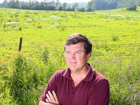 Bernie DeGagne stands in his yard on County Road 2, next to property that is being proposed for the Middle Road Solar Farm.