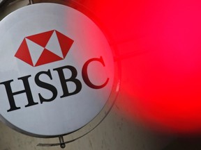 A traffic light shines red near the HSBC bank logo, pictured at the bank building in Paris, in this June 15, 2015 file photo. (REUTERS/Christian Hartmann)