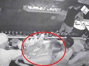 A screen grab from security footage allegedly showing FSU QB De'Andre Johnson punching a female bar patron.