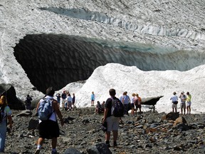 In this July 2010 photo, visitors examine the Big Four Ice Caves in the Mt. Baker-Snoqualmie National Forest near Granite Falls, Wash. The Snohomish County sheriff's office says rescuers responded to a report of a partial collapse of the ice caves Monday, July 6, 2015. Mark Mulligan/The Herald via AP