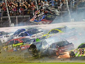 In this photo made early Monday, July 6, 2015, Austin Dillon (3) goes airborne as he was involved in a multi-car crash on the final lap of the NASCAR Sprint Cup series auto race at Daytona International Speedway in Daytona Beach, Fla. (AP Photo/Rob Sweeten)