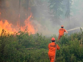 Firefighters tackle a wildfire near the town of La Ronge, Sask., on July 5, 2015, in a picture provided by the Saskatchewan Ministry of Government Relations. (REUTERS/Saskatchewan Ministry of Government Relations/Handout via Reuters)