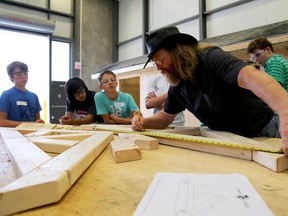 EMILY MOUNTNEY-LESSARD/THE INTELLIGENCER
Larry Burnett, Loyalist College professor, helps students build a truss during a Skills Ontario workshop at Loyalist College, Tuesday in Belleville.