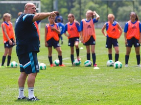 Mark Ridgeway of England instructs at the International soccer camp run by Academy Garrincha in London, Ont. on Monday July 6, 2015. (Mike Hensen/The London Free Press/Postmedia Network)