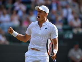 Canada's Vasek Pospisil reacts during his men's singles third round match against Britain's James Ward on day six of the 2015 Wimbledon Championships at The All England Tennis Club in Wimbledon, southwest London, on July 4, 2015. Pospisil won 6-4, 3-6, 2-6, 6-3, 8-6.  (AFP PHOTO / GLYN KIRK)