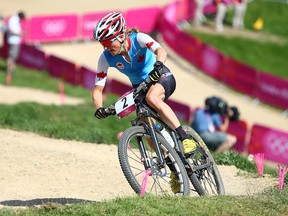Catharine Pendrel of Canada climbs the hill during the Women's mountain bike race during the 2012 Olympic Summer Games in London August 11, 2012. (Dave Abel/Toronto Sun)