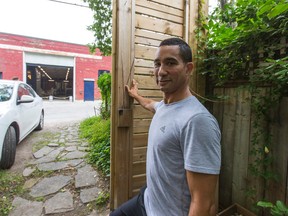 Collin Chow looks out his backyard at Left Field Brewery across the laneway in Toronto on Tuesday July 7, 2015. (Ernest Doroszuk/Toronto Sun)
