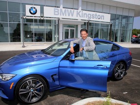 Scott Douglas, the general manager and managing partner of the new BMW dealership in Kingston, with a $70,000 2015 435 X Drive Grand Coupe on Tuesday July 7 2015. Ian MacAlpine/The Kingston Whig-Standard/Postmedia Network