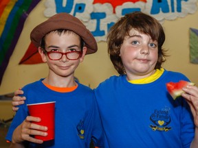 Michael Suart, left, and Austin Patrick are the best of friends and like playing video games and talking with each other at the Extend-A-Family 25th Anniversary celebration held in Kingston, Ont. on Tuesday July 7, 2015. Julia McKay/The Kingston Whig-Standard/Postmedia Network
