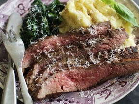 This June 15, 2015 photo shows marinated flank steak with seared spinach in Concord, N.H. This dish is from a recipe by Alison Ladman.