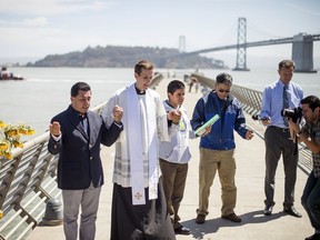 Father Cameron Faller leads a prayer vigil for shooting victim Kathryn Steinle on Pier 14 in San Francisco on July 6, 2015. Steinle was fatally shot as she walked with her father along the popular Embarcadero pier on July 1, 2015 in what San Francisco police described as an apparent random attack. REUTERS/Noah Berger
