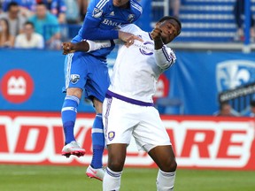 Montreal Impact defender Laurent Ciman (23) heads the ball next to Orlando City FC forward Cyle Larin (21) at Stade Saputo June 20, 2015 in Montreal. Larin is playing for Canada in the Gold Cup. (Jean-Yves Ahern-USA TODAY Sports)