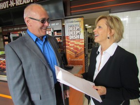 Rob Taylor, chairperson of the Sarnia Lambton Chamber of Commerce, left, and Little Ceasars franchise owner Kathleen Mundy talk on Wednesday July 8, 2015 in Sarnia, Ont., at an event marking the release of a provincial chamber of commerce report on higher electricity costs. (Paul Morden/Sarnia Observer/Postmedia Network)