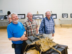 Bert Riggall’s grandsons John, Gordon and Charlie Russell stand next to a display showing the two-man diamond gear packing technique at photography exhibit on June 24, 2015. John Stoesser photos/Pincher Creek Echo.