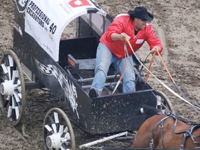 B.J. Carey comes off the barrels in Heat 2 of the Rangeland Derby chuckwagon races at the Calgary Stampede in Calgary, Alta., on July 4, 2015. (Mike Drew/Calgary Sun/Postmedia Network)