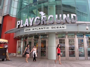 In this June 26, 2015 photo, customers leave The Playground, developer Bart Blatstein's $52 million remake of the former Pier Shops complex, in Atlantic City, (AP Photo/Wayne Parry)