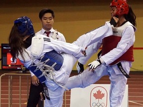 Danielle Ennett lands a kick to the face of her opponent in the bronze-medal match at the national black belt team selections in Montreal. Ennett won bronze, as did fellow Sarnia Olympic Taekwondo Academy members Urvashi Thongam and Jewelian Blackbird. (Handout/Sarnia Observer/Postmedia Network)