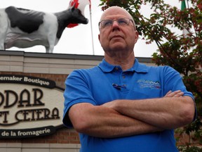 Jacques Leury, owner of Cheddar Et Cetera, poses for a photo in front of his Orleans store in 2011. The cow on his roof was being debated at Ottawa City Hall this week.  TONY CALDWELL/OTTAWA SUN FILES