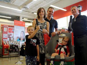 SARAH HYATT/THE INTELLIGENCER
Isaac and Aurora Whalen (in front), with parents Kristen and Chris and franchise owner Wayne Dewe (right), display Caroline’s Cart at Dewe’s Independent Grocers in Belleville.