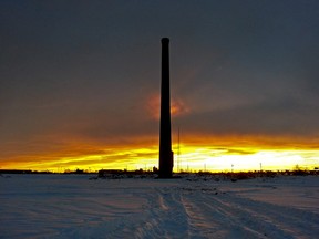 The sun sets behind the historical ten-storey brick smokestack on Fort Road just north of Yellowhead Trail. The smoke stack is the only thing still standing from the Canadian Packers Plant that was originally built in 1936.  Max Maudie/Edmonton Sun