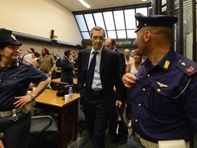 Nicolo Ghedini, lawyer of Silvio Berlusconi, leaves the Naples court, Italy, Wednesday, July 8, 2015. A court in Naples Wednesday convicted former Italian Premier Silvio Berlusconi of corruption charges accusing him of bribing a senator to weaken the government of his arch political rival. The court also gave the media mogul a three-year prison sentence. (AP Photo/Salvatore Laporta)