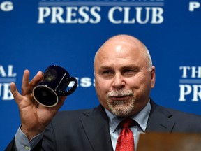 Capitals head coach Barry Trotz holds up a coffee mug he was presented with after speaking at the National Press Club in Washington on Wednesday, July 8, 2015. (Susan Walsh/AP Photo)