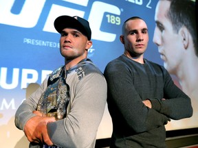 UFC Welterweight champion Robbie Lawler stands with Rory MacDonald at Flames Central in Calgary on March 25, 2015. (Stuart Dryden/Calgary Sun)