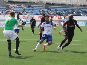 FC Edmonton’s Sadi Jalali (middle) chases down the ball in front of San Antonio goalkeeper Daryl Sattler at SMS Equipment Stadium in Fort McMurray Sunday. Robert Murray/Postmedia network