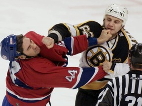 Andrei Nazarov (right) is seen here fighting Sheldon Souray during a game between the Bruins and Canadiens in 2001. Nazarov, the head coach of the KHL's SKA St. Petersburg, is being accused of beating up the team's doctor. (Jim Bourg/Reuters/Files)