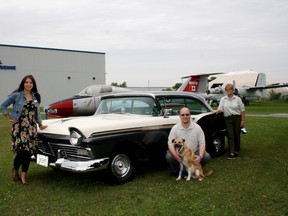 SARAH HYATT/THE INTELLIGENCER
Brigitte Frances, development co-ordinator for the National Air Force Museum of Canada Foundation (left), Frank Rockett, executive director for the Quinte Humane Society with Finnigan and Irene Redpath, a member of the board of directors for the humane society (right), show off a 1957 Ford Fairlane 500, two-door hardtop at CFB Trenton museum grounds. In the background is a Tutor plane. Redpath helped come up with the idea for the society and foundation’s Wings and Wheels Classic Car Show. Finnigan is up for adoption.